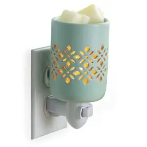 Harmony Spa plug-in wax warmer with decorative cutout design shown on a white background